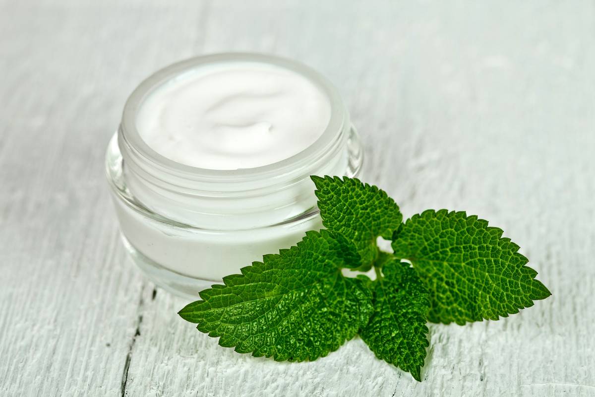 Close-up of natural lotion texture in a glass jar showing rich organic consistency
