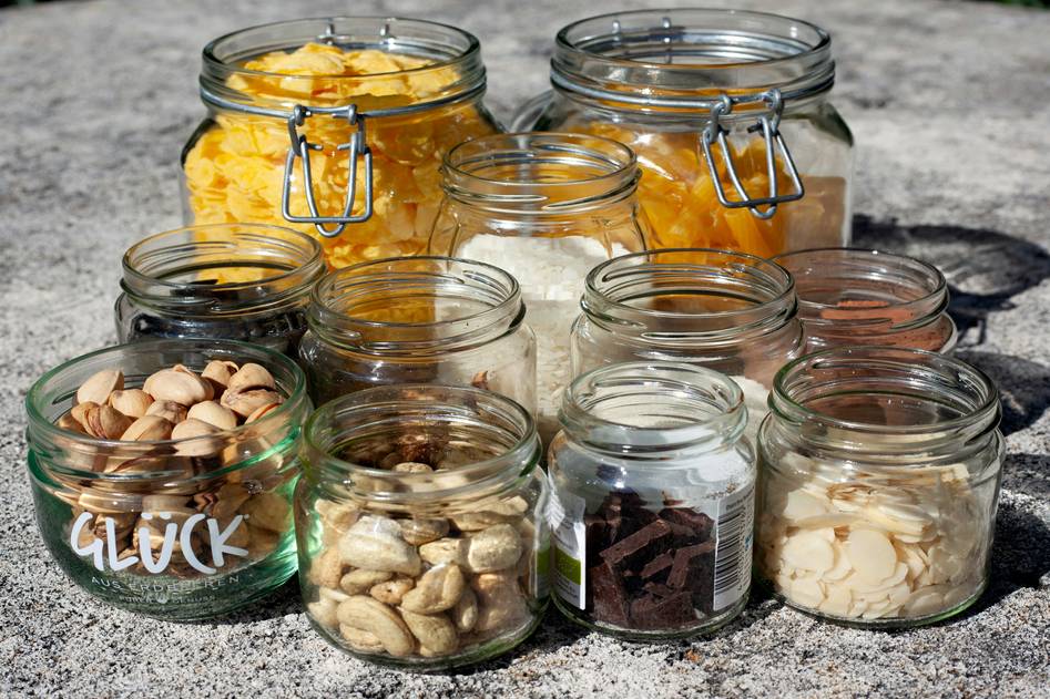 Organic skincare ingredients arranged on wooden table with fresh herbs and oils